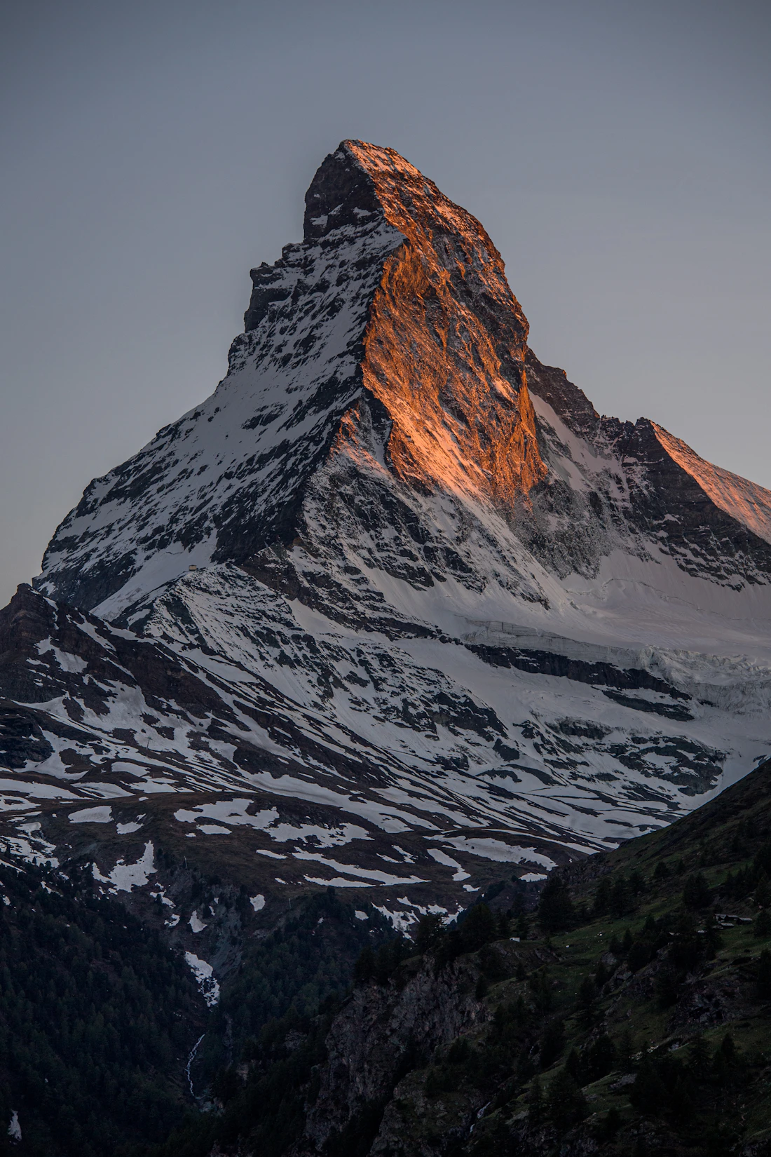 The snow-covered Matterhorn against a clear winter sky in the Swiss Alps