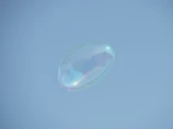 a soap bubble floating in the air on a clear day