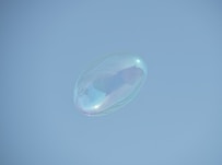 a soap bubble floating in the air on a clear day