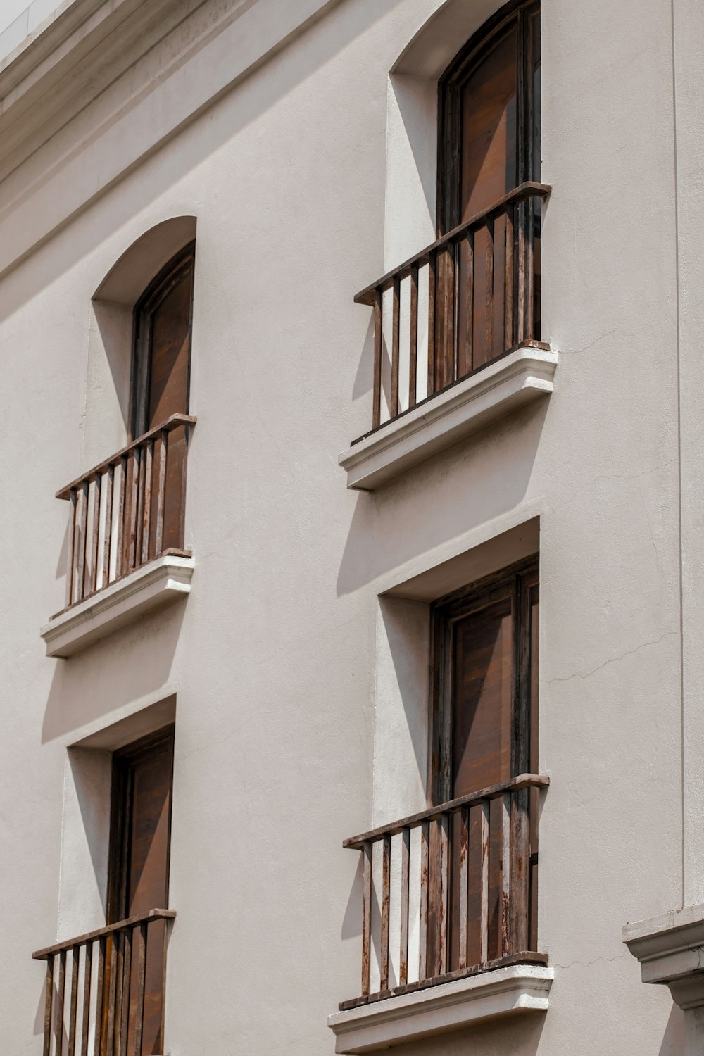 a building with two balconies and a clock on the side of it