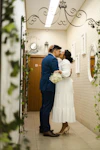 a bride and groom kissing in a hallway