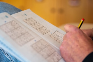 a person is holding a piece of paper with numbers on it