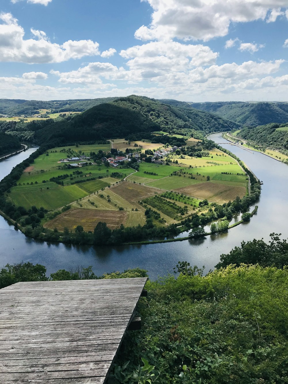 a river running through a lush green countryside