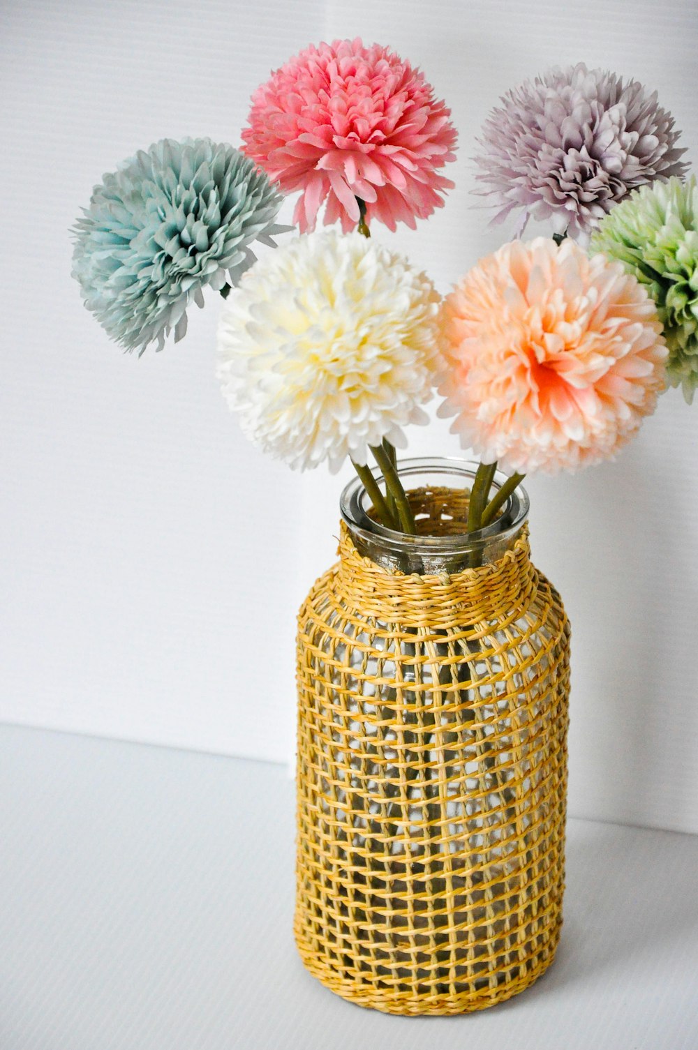 a vase filled with flowers sitting on top of a table