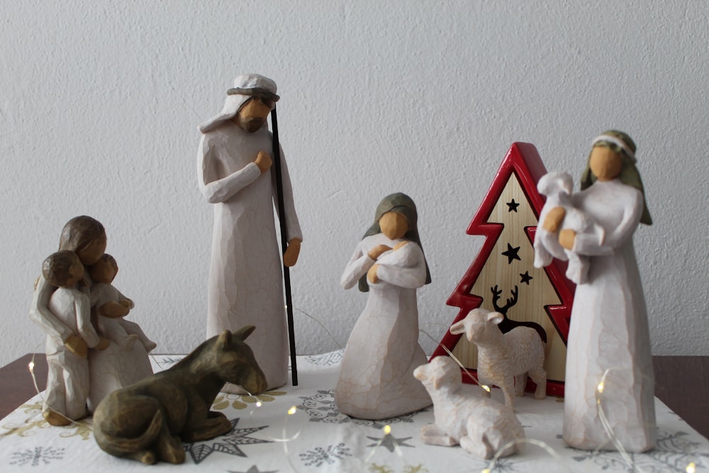 a nativity scene with figurines of people and a dog