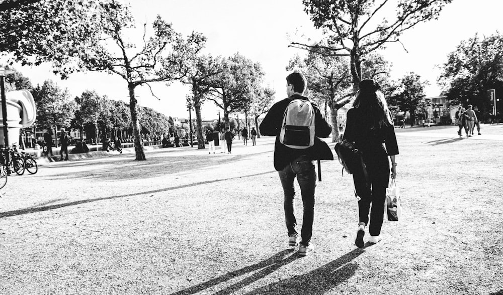 a couple of people that are walking down a street