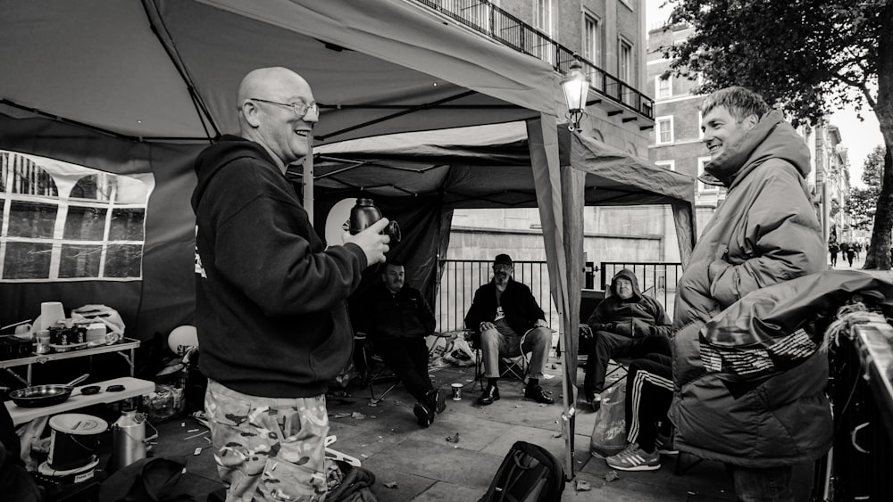 a group of people sitting under a tent