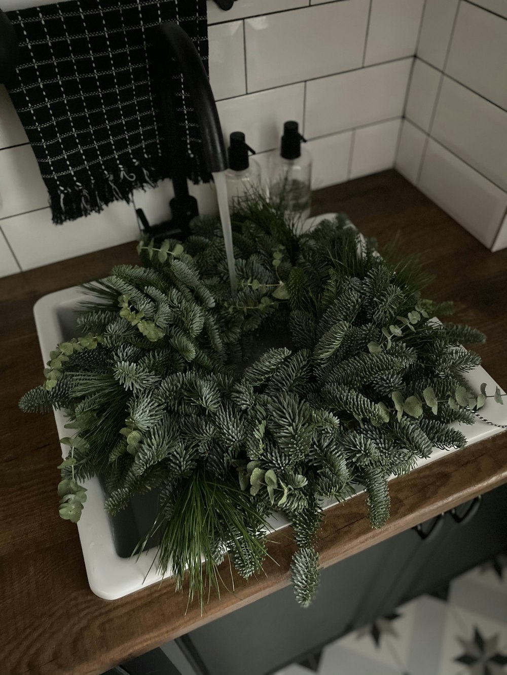 a white sink sitting under a faucet next to a wooden counter