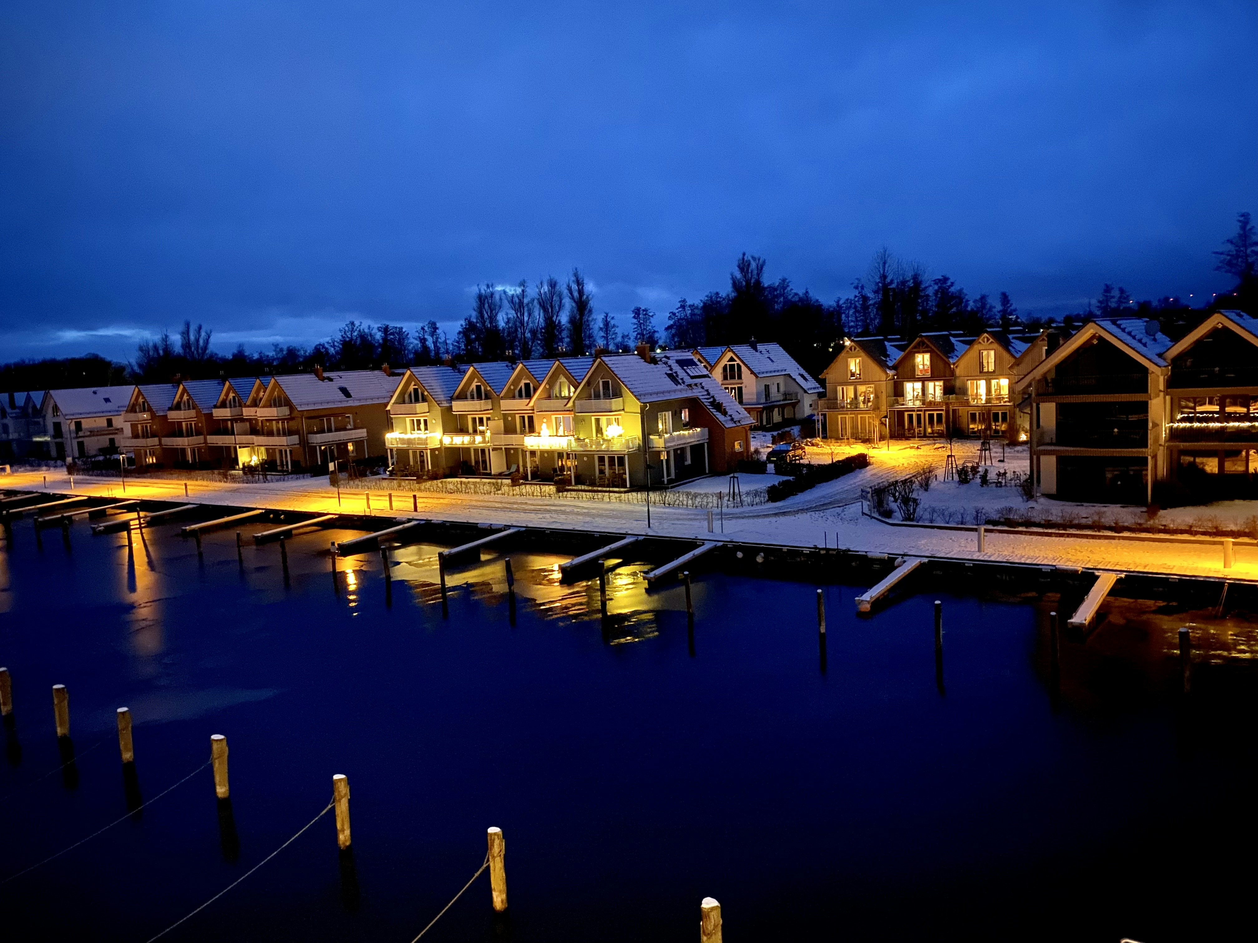 a group of houses sitting on top of a lake