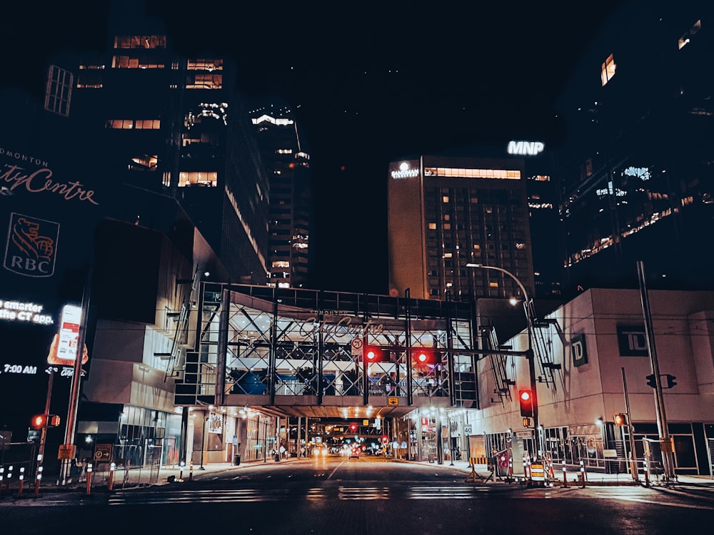 a city street at night with traffic lights