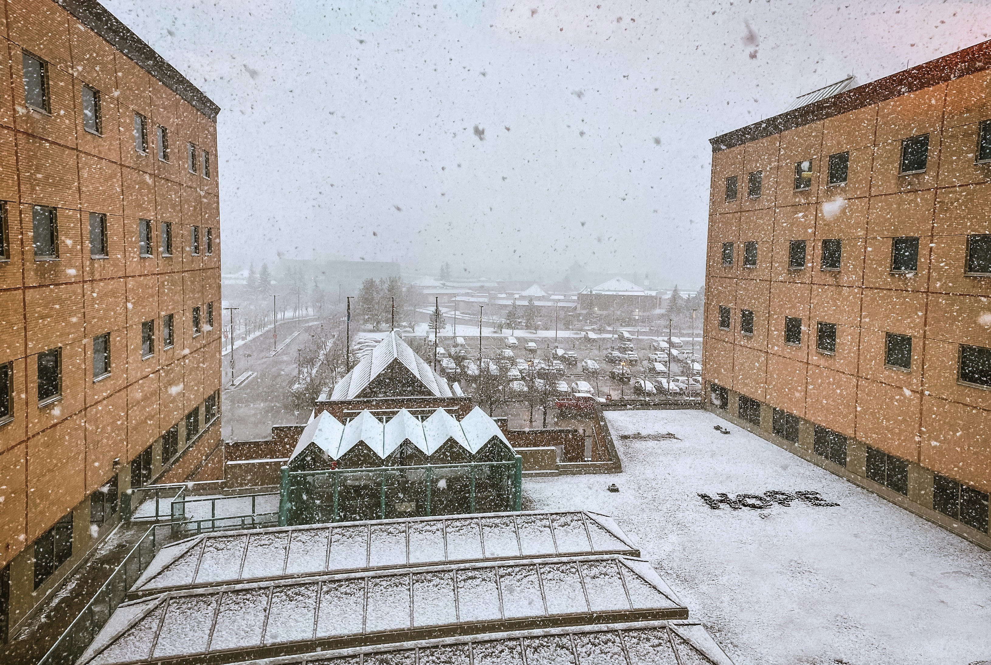 a snowy view of a city from a window