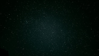 A serene midnight sky sprinkled with soft gold stars, evoking a sense of calm and celestial mystery.