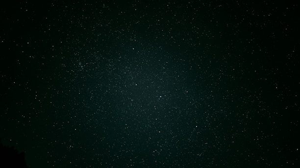 A serene midnight sky sprinkled with soft gold stars, evoking a sense of calm and celestial mystery.