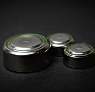 a group of three batteries sitting on top of a table