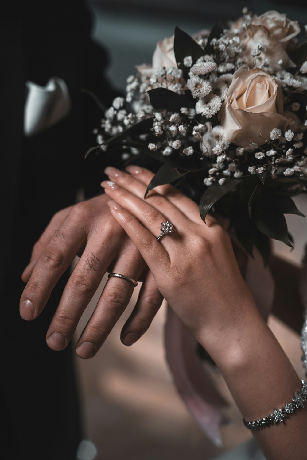 a close up of a person holding a bouquet of flowers