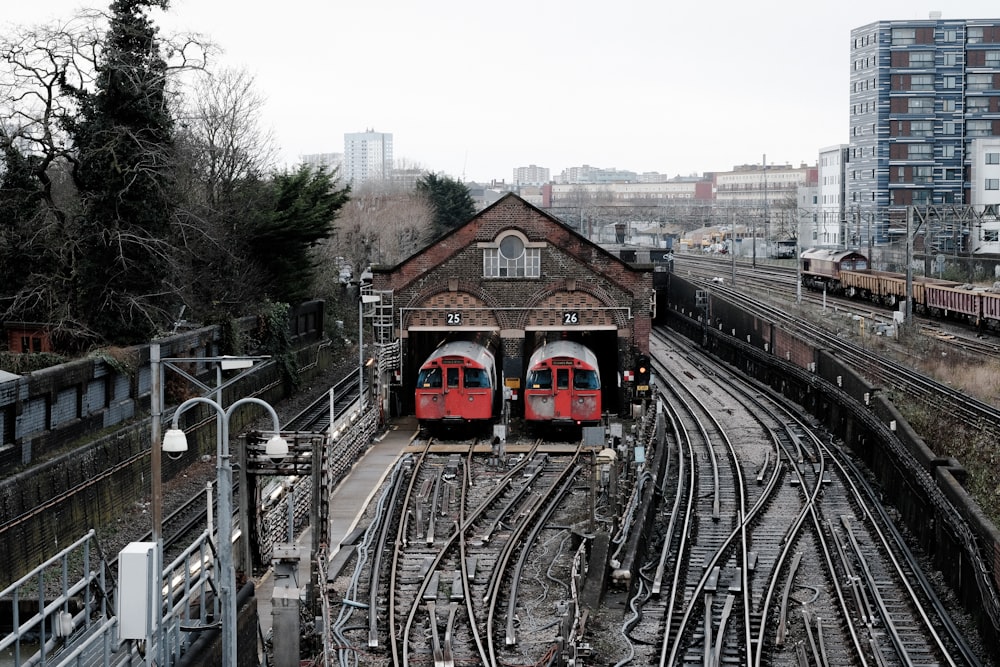 a train station with two trains on the tracks