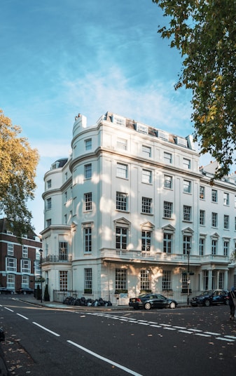 a large white building sitting on the side of a road
