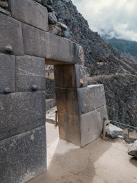 a stone structure with a door in the middle of it