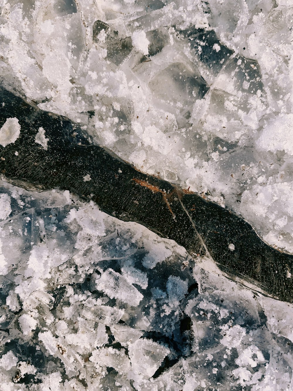 a long piece of ice sitting on top of a body of water