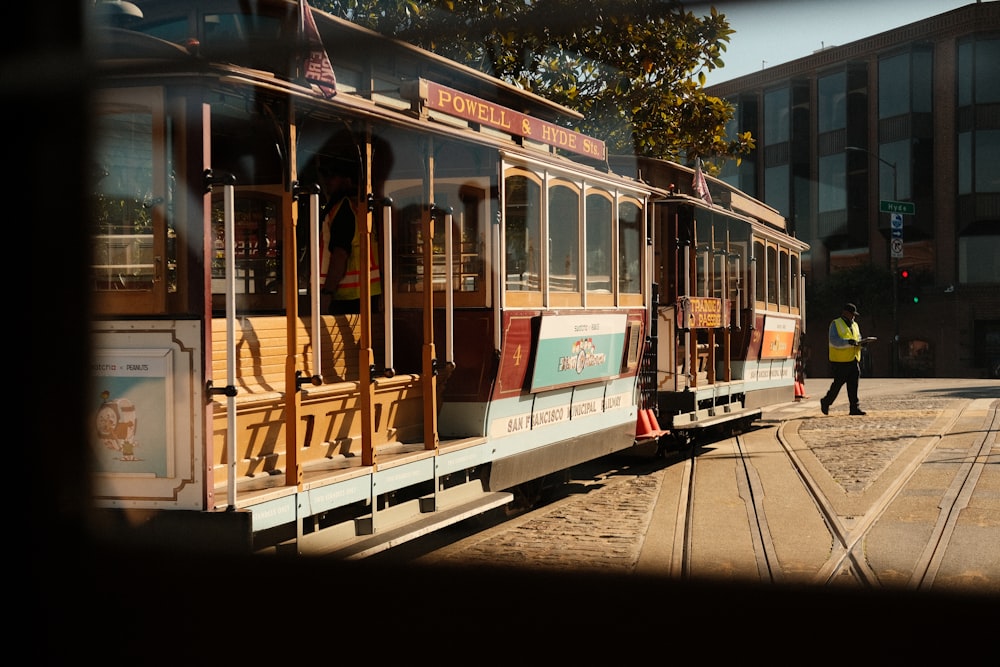a trolley car is parked on the side of the road