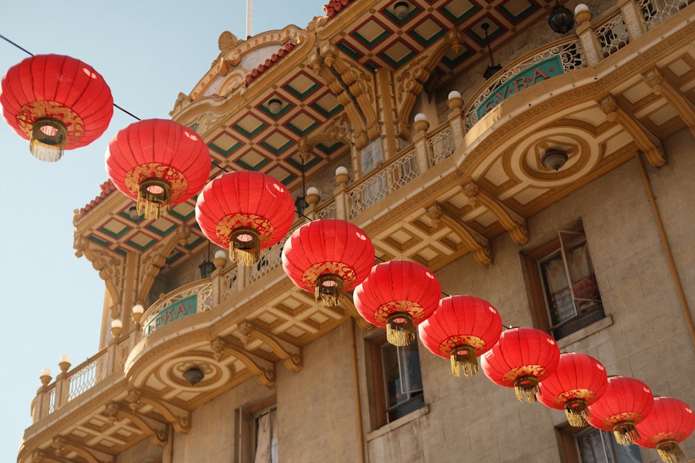 a building with red lanterns hanging from it's side