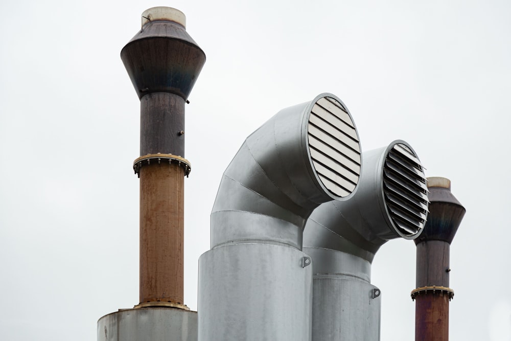 a group of metal pipes with a sky in the background