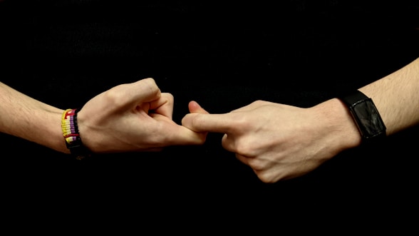 two hands holding making the friends sign in Sign language