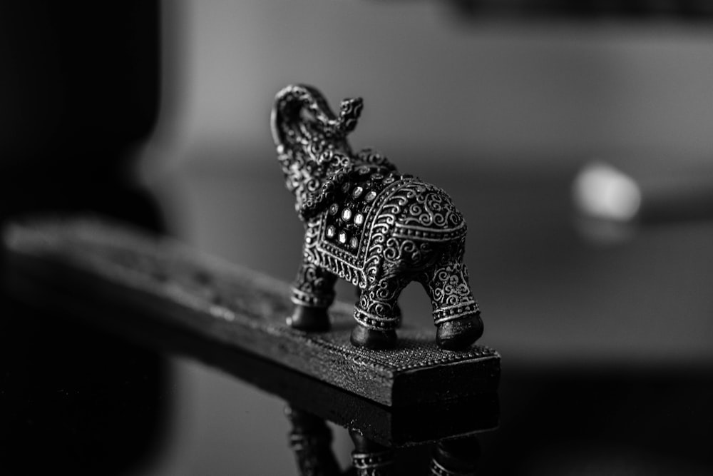 an elephant figurine sitting on top of a wooden table