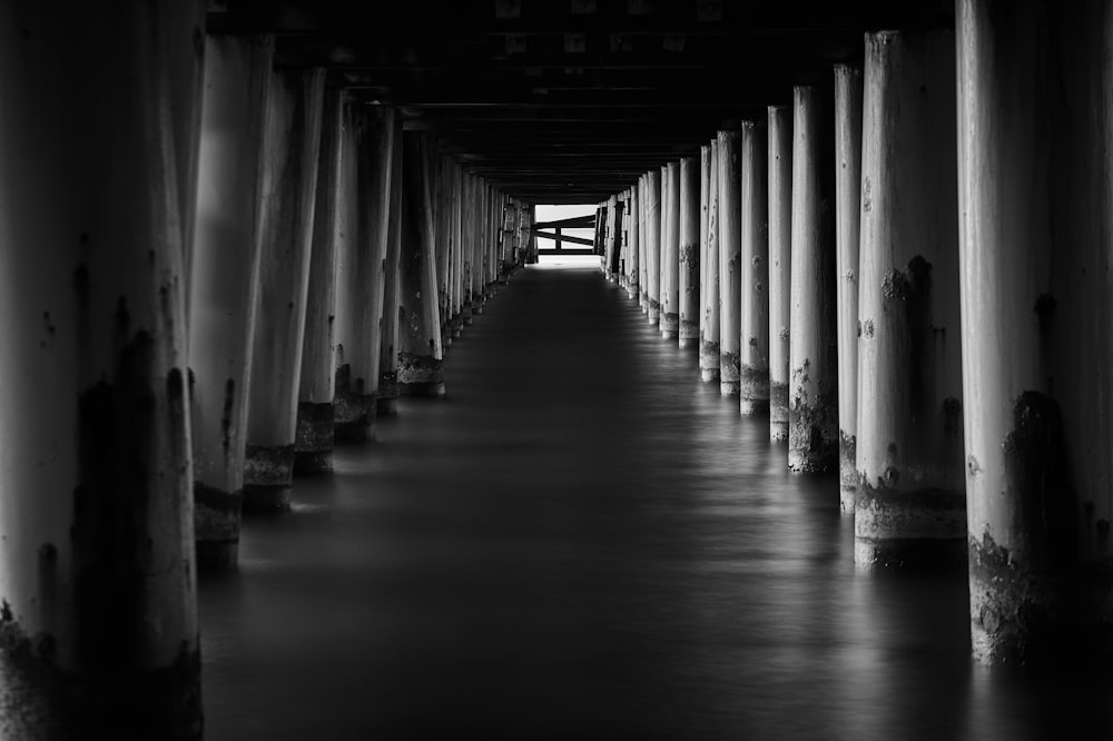 a black and white photo of a long pier