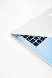 a close up of a laptop on a white surface