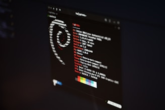 A computer screen displaying system information for a Debian GNU/Linux distribution. The background is dark with a prominent logo formed by ASCII art. Technical details such as OS version, host name, uptime, resolution, and other specs are presented in white and red text.
