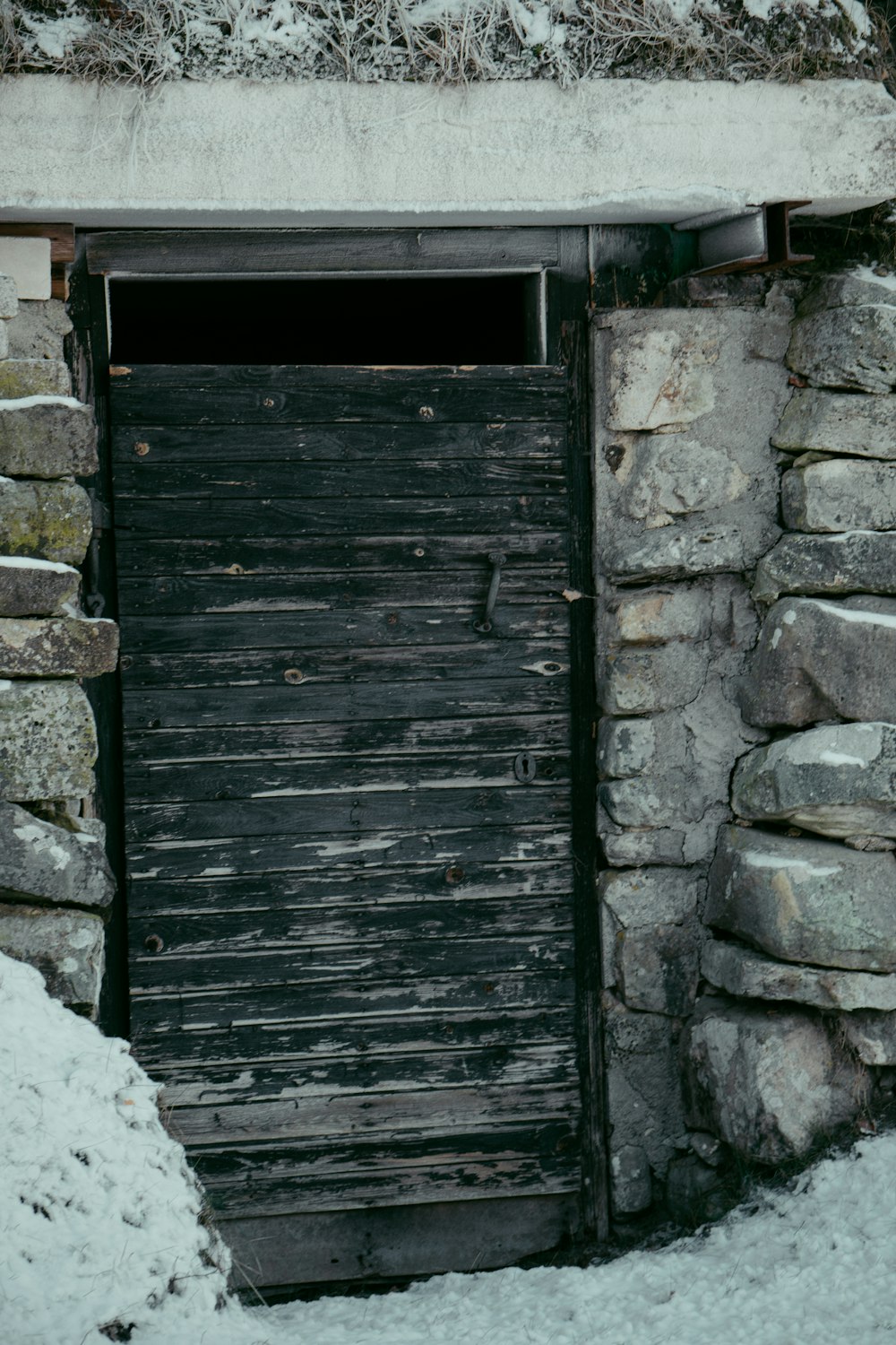 an old wooden door in a stone wall