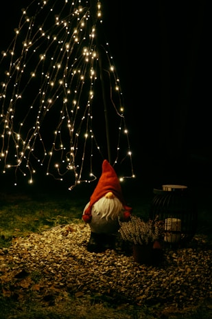 a person kneeling down next to a christmas tree