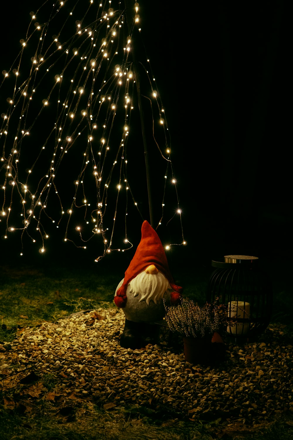 a person kneeling down next to a christmas tree