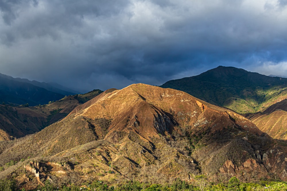 a view of a mountain range under a cloudy sky