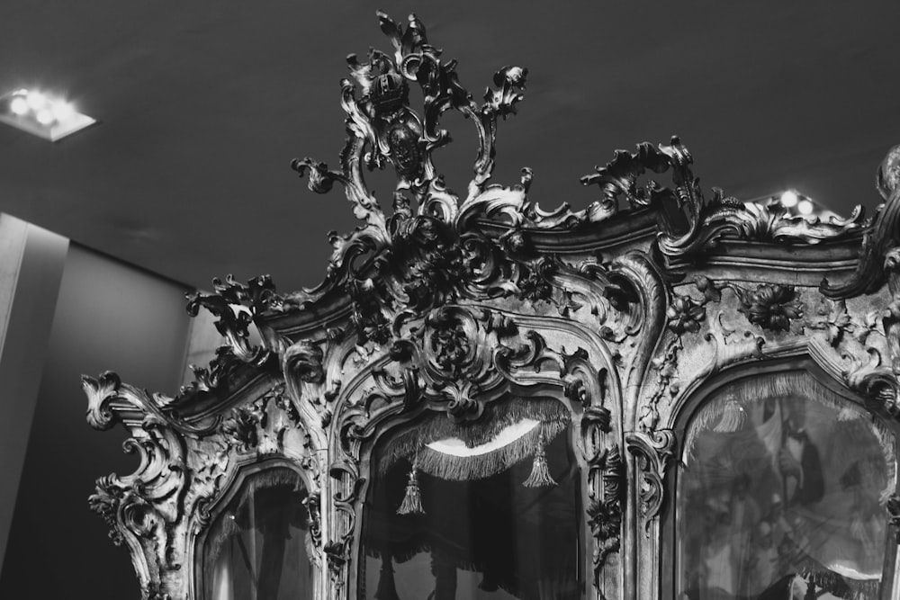 an ornately decorated cabinet with mirrors in a room