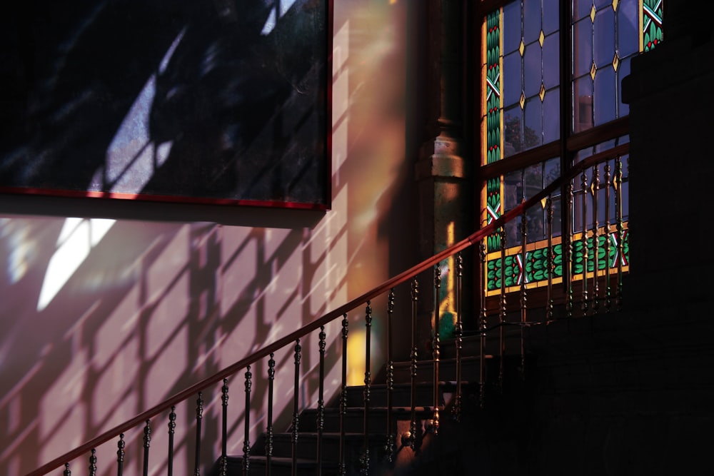 a stair case with stained glass windows and railings