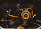 a close up of a car engine with yellow hoses