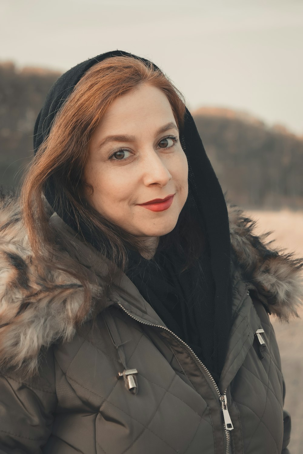 a woman in a parka with a hood on