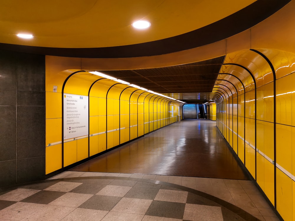 a long yellow tunnel with a checkered floor