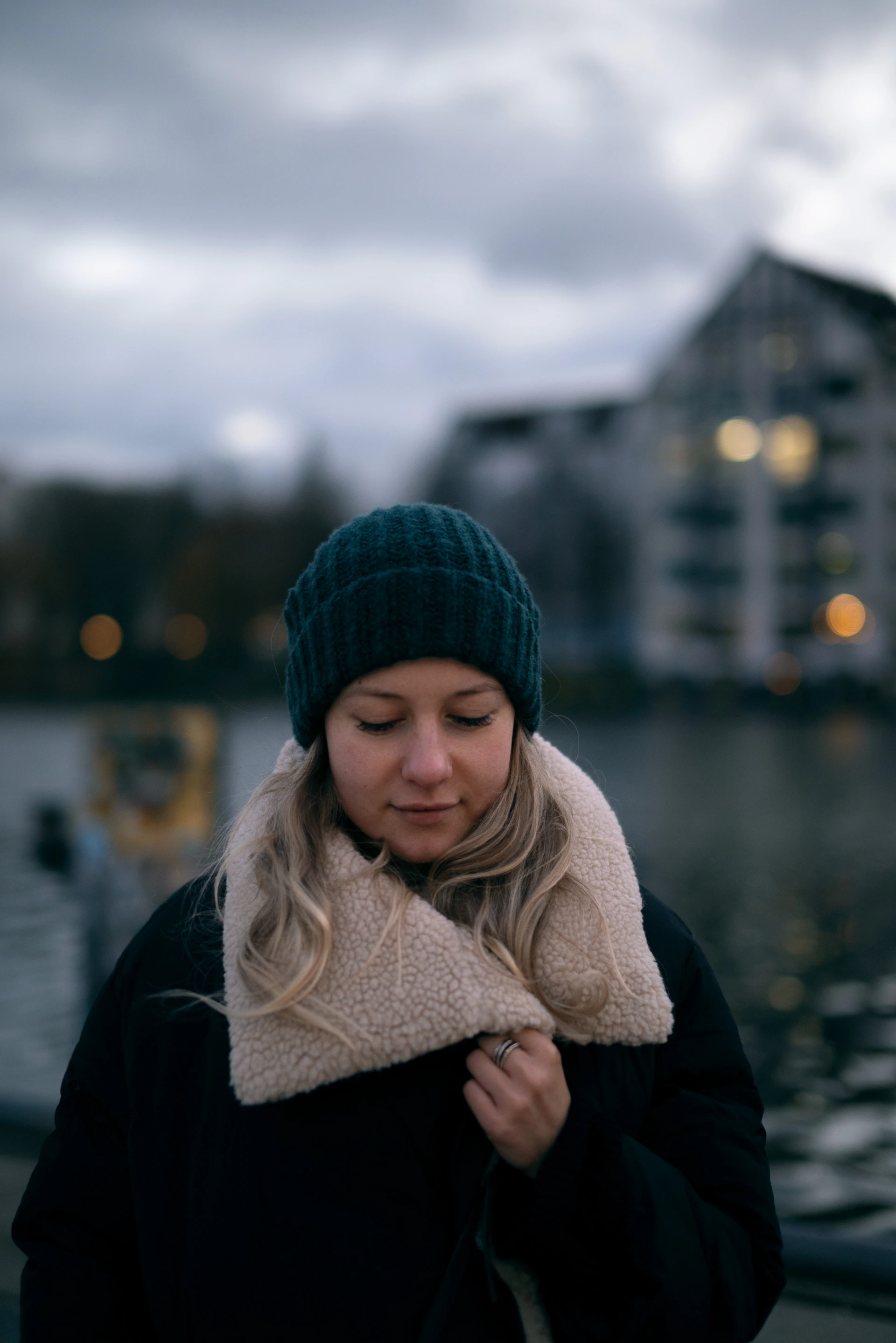 a woman standing next to a body of water