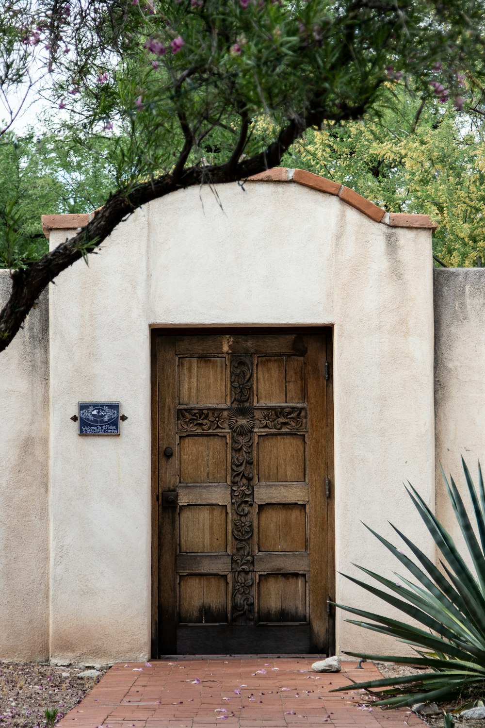 a wooden door in a white stucco building