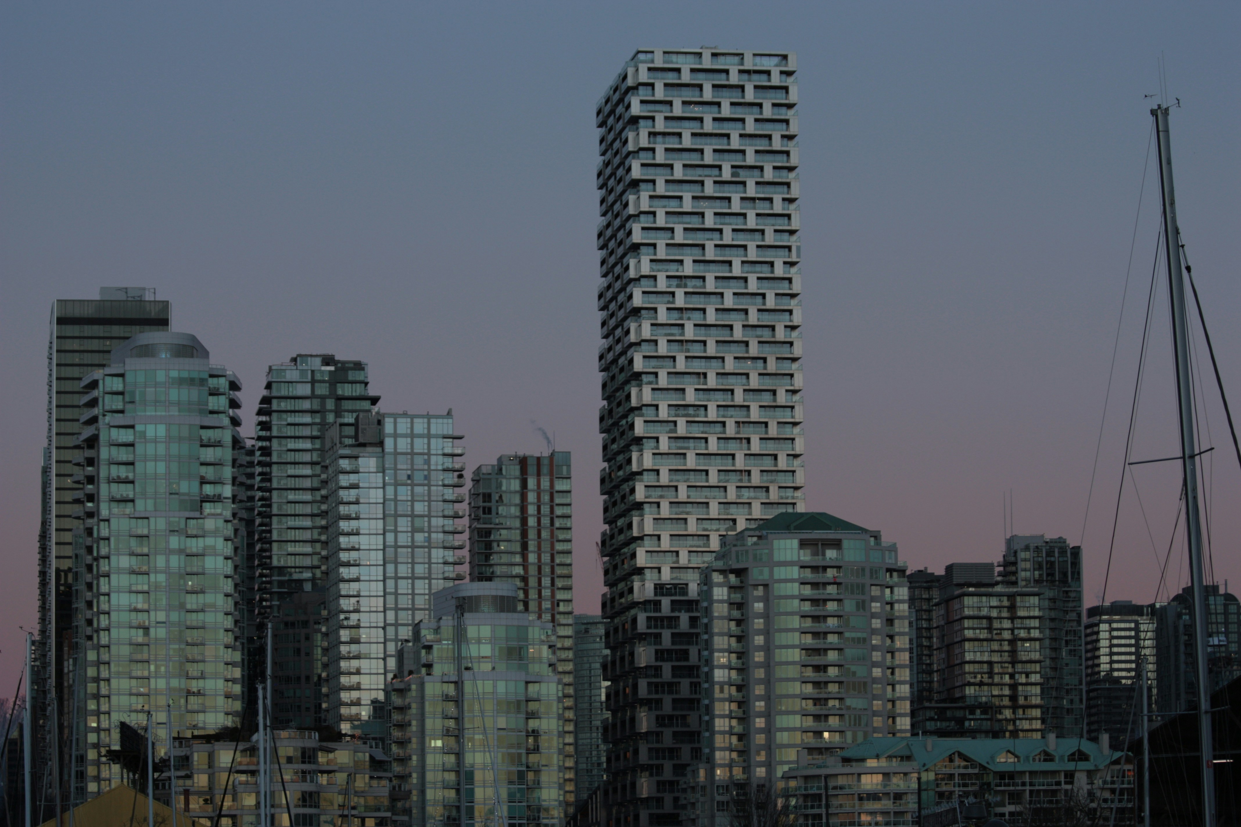 a tall building with a lot of windows next to a body of water