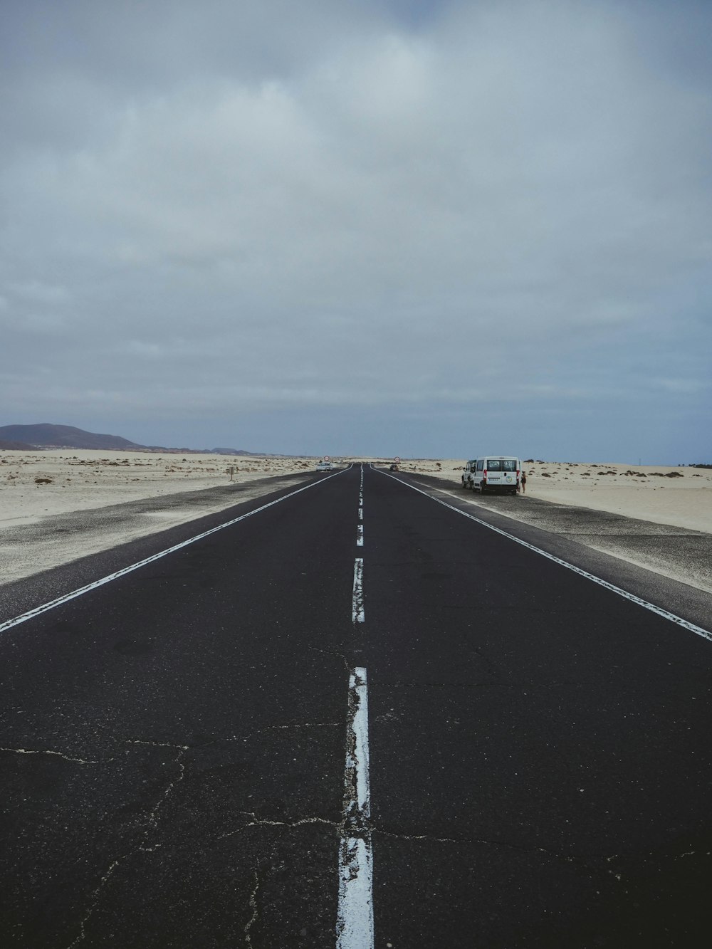 a truck is driving down a deserted road