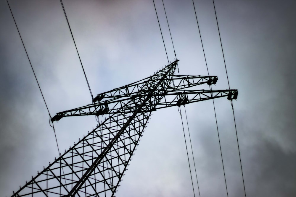 a high voltage power line against a cloudy sky