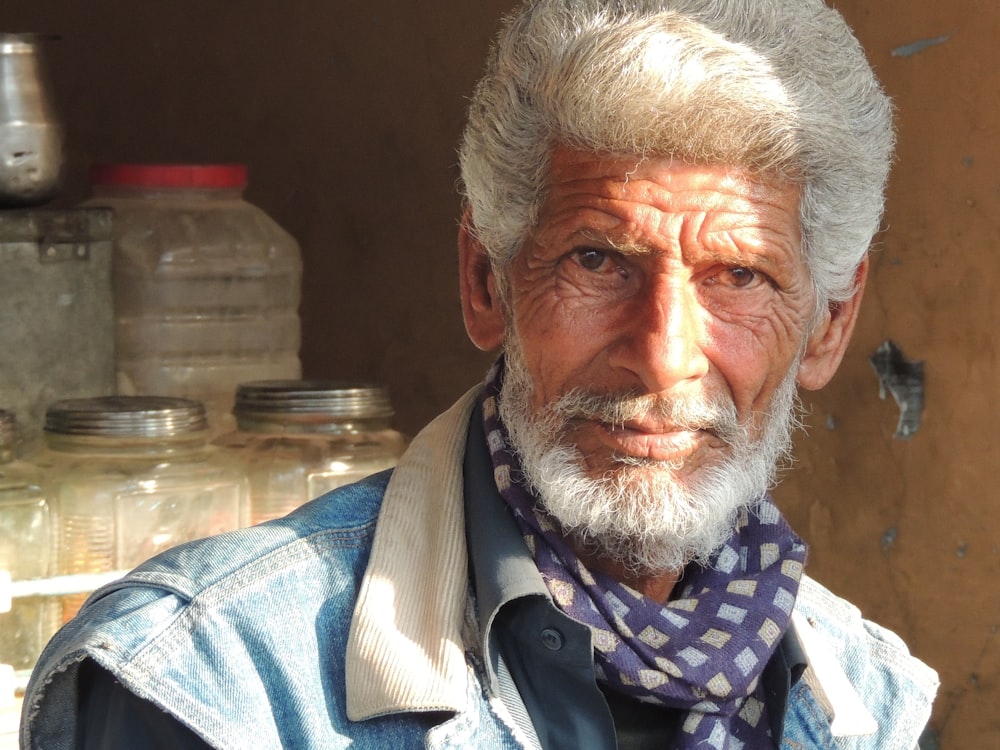 an old man with a scarf around his neck