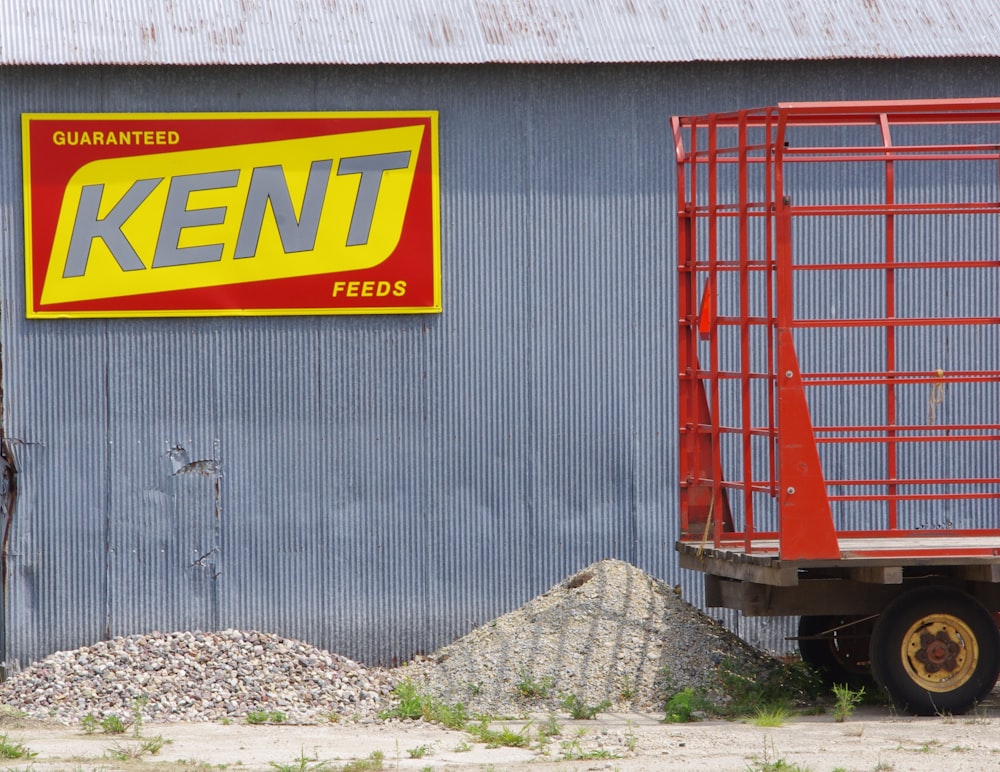 a red and yellow truck parked in front of a building