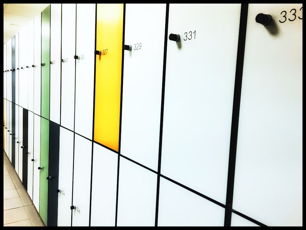 a row of white and yellow lockers next to each other