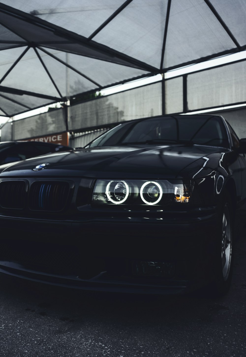 a black car parked in a parking garage