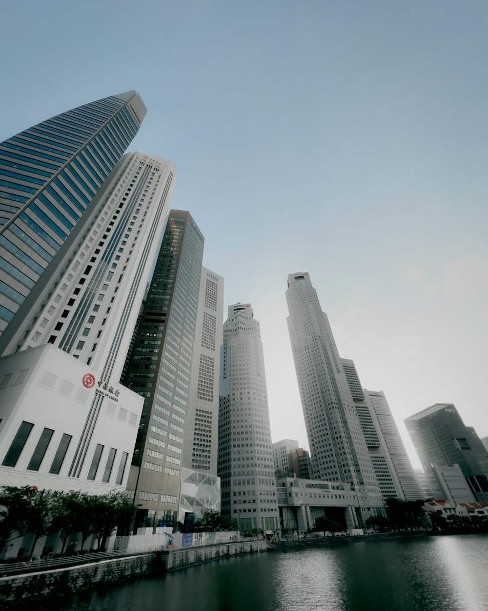 a group of tall buildings next to a body of water